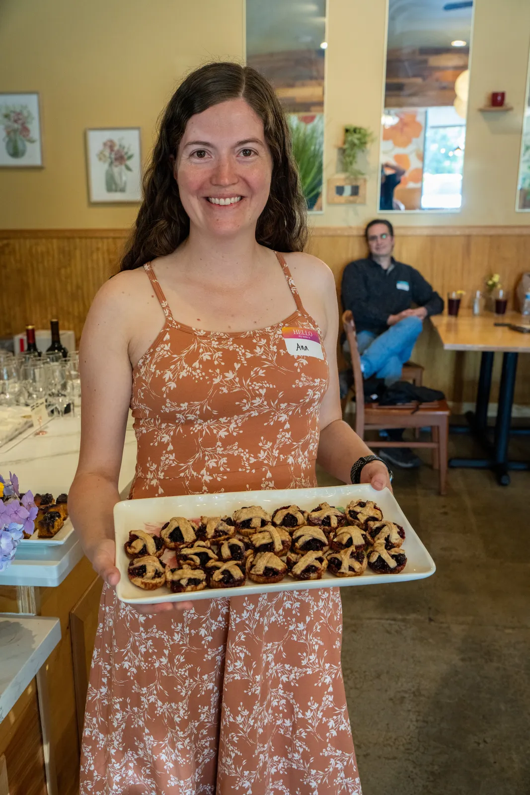 A baker with her tray of chocolate bites