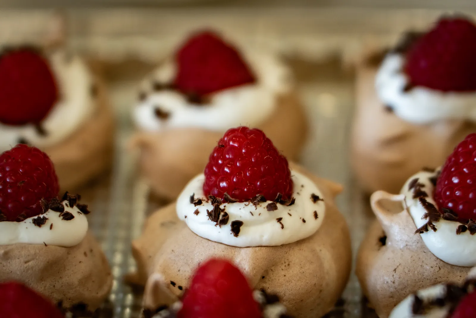 Chocolate meringue bites topped with fresh raspberries