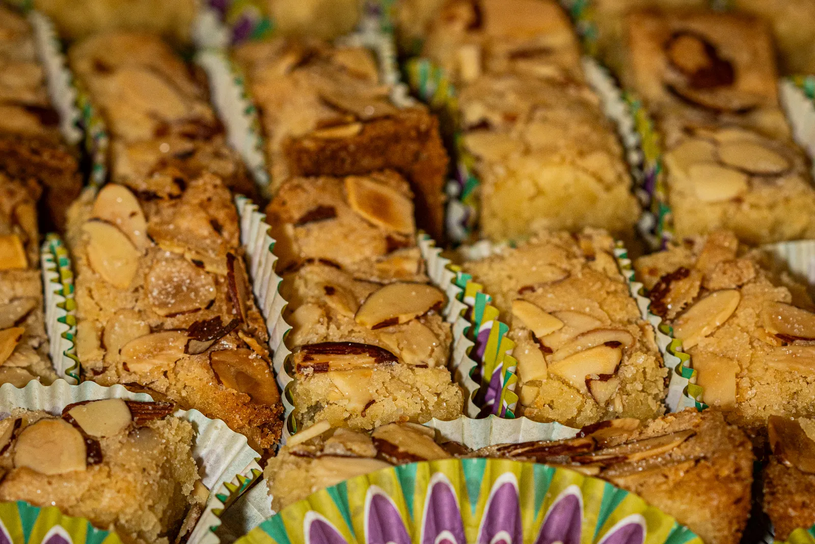 Golden cookie bars in colorful wrappers