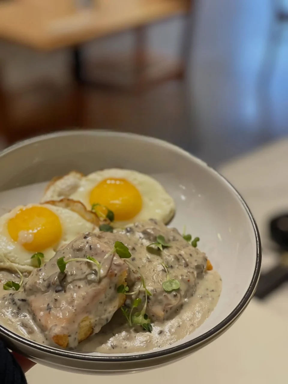 Biscuits with mushroom gravy served with sunny-side-up eggs